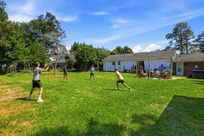 Spacious backyard with patio seating and room for fun outdoor games