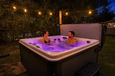 Private backyard hot tub under string lights for a relaxing evening soak