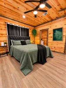 Rustic-chic bedroom with plush king bed and warm cabin-style charm