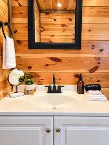 Rustic bathroom vanity with warm wood walls and stylish modern touches