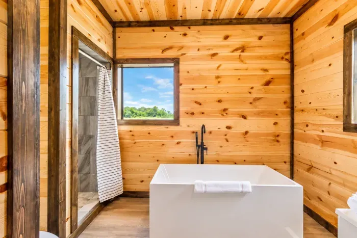 Spa-like bathroom with soaking tub, walk-in shower, and rustic charm