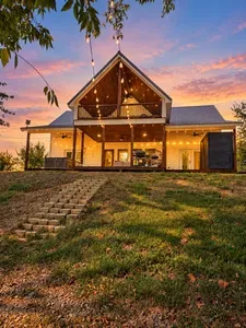 Stunning sunset views from a warmly lit cabin with spacious outdoor living