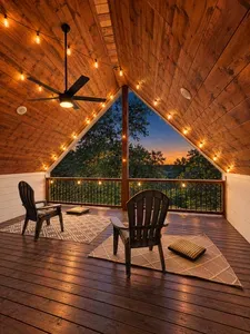 Cozy covered deck with sunset views, string lights, and Adirondack seating