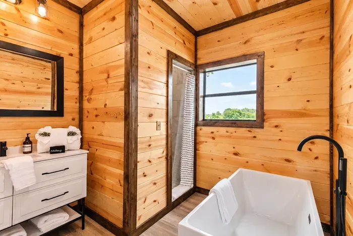 Rustic spa-style bathroom with soaking tub and scenic window views