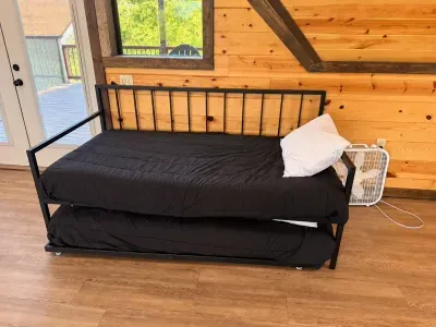 Cozy cabin daybed with trundle and deck access