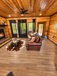 Cozy wood-clad living room with fireplace and easy outdoor access