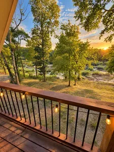 Sunset river views from a cozy private deck with string lights