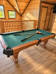 Cozy loft game room with pool table and warm cabin charm