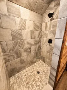 Spacious walk-in shower with upscale tilework and modern finishes