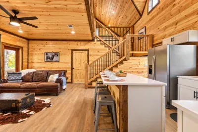 Rustic-modern cabin great room with vaulted ceilings and kitchen island