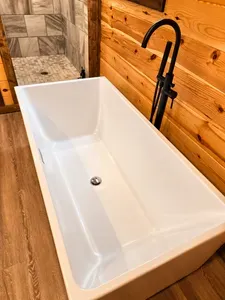 Rustic spa bath with soaking tub and elegant walk-in tiled shower