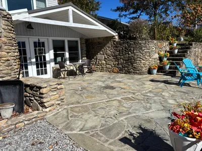Private stone patio with covered seating and sunny lounge space