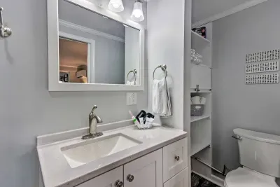 The bathroom is a perfect size for two guests and has extra shelf space. There is also a hair dryer in the bottom shelf of the vanity.