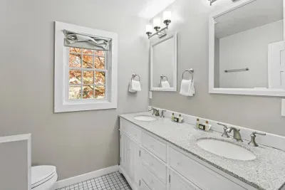 The bathroom off the Bunk Bed features a double sink and a bright, white design.