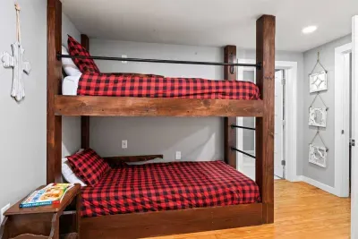Each bunk bed comes with it's own wall outlet and shelf for charging electronics. The room also has two children's books. 