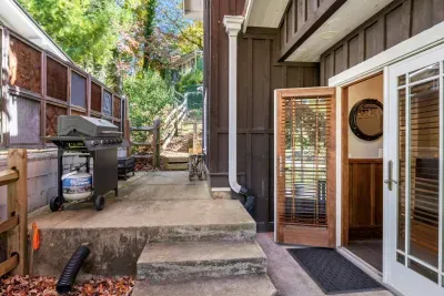 The back patio offers a privacy barrier and a BBQ grill for cooking. 