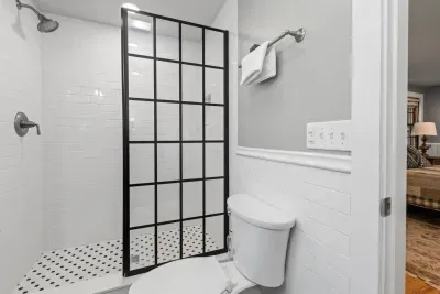 The upstairs bathroom is private to bedroom 2 and has a stylish design with a standing shower. 