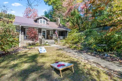 Enjoy setting up Corn Hole to play a game amidst the luscious plants and trees in the front lawn.
