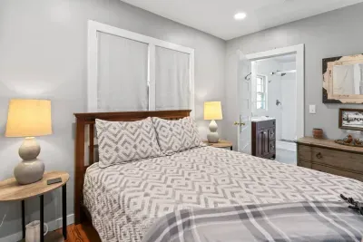 Primary bedroom situated on the main level adjacent to the living room.