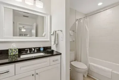The secondary bathroom includes one sink and a shower/tub combo. 