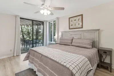 Step out of the Master Bedroom onto the patio to take in the fresh air from the greenery surrounding this condo. 