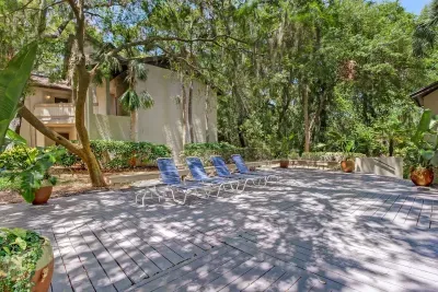 The shared community pool is shaded and includes loungers, perfect for working on a tan without too much sun bearing down. 