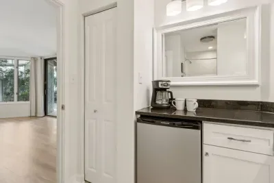 Store additional food or drinks in the secondary bathroom's mini fridge. This bathroom also has an extra linen closet perfect for storing anything additional during your stay.