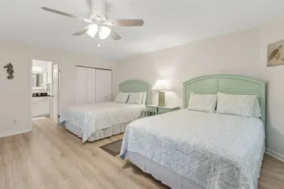 Two queen-sized beds are in this oversized, secondary bedroom, that sleep 4 guests. There is a private bathroom attached to the bedroom and a separate entrance.