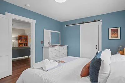 Spacious master bedroom with ample clothes storage, featuring a large dresser and a roomy closet!
