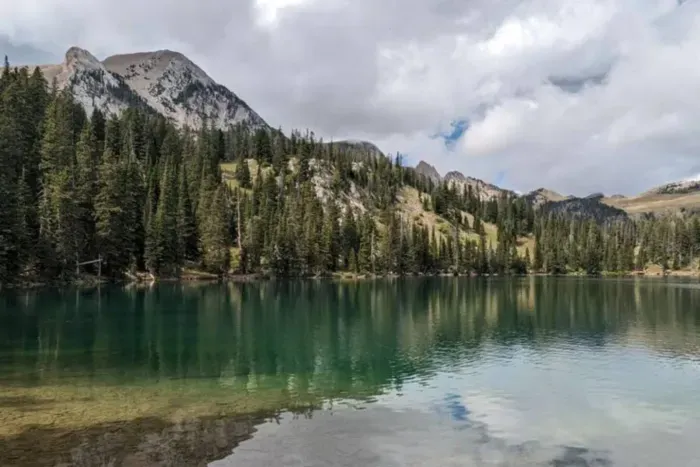 Fairy Lake Trail near Bozeman offers a short, scenic hike with crystal-clear alpine water, wildflowers, & views of Sacagawea Peak. Great for families, fishing, & picnics. Accessible once snow has melted. 39 miles from The Cabins at Wheat Ridge Farm.