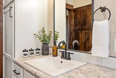 Bright vanity with matte black fixtures, cozy decor, and all the essentials. Perfect for getting ready or winding down.