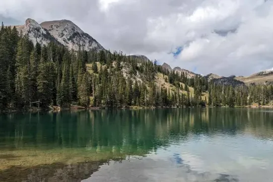 Fairy Lake Trail near Bozeman offers a short, scenic hike with crystal-clear alpine water, wildflowers, & views of Sacagawea Peak. Great for families, fishing, & picnics. Accessible once snow has melted. 39 miles from The Cabins at Wheat Ridge Farm.
