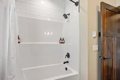 Fresh, spa-inspired bathroom with a full tub/shower combo, soft lighting, and strong water pressure for a relaxing rinse after a day of exploring.
