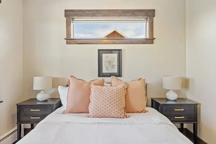 Perfect for couples, this bedroom offers privacy and comfort with a luxury mattress, quiet ambiance, and a window view of the mountains. You'll also find an iron, phone charger, and sound machine in the nightstand drawer.