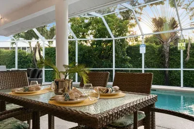 Dining Area: Savor meals poolside with lush views and a touch of tropical elegance!