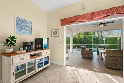 Sunroom Oasis: Enjoy morning coffee with a view, just steps from the refreshing pool!