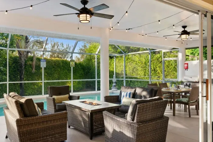 Outdoor Oasis: Relax by the pool in style with comfy seating and sparkling string lights!