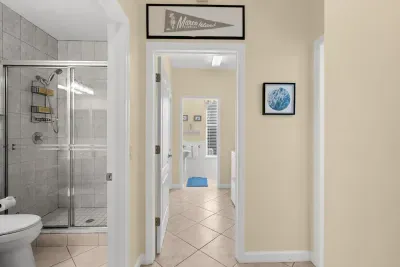 Hallway Bathroom: Spa-like shower and beachy decor invite rejuvenation after sun-soaked adventures!