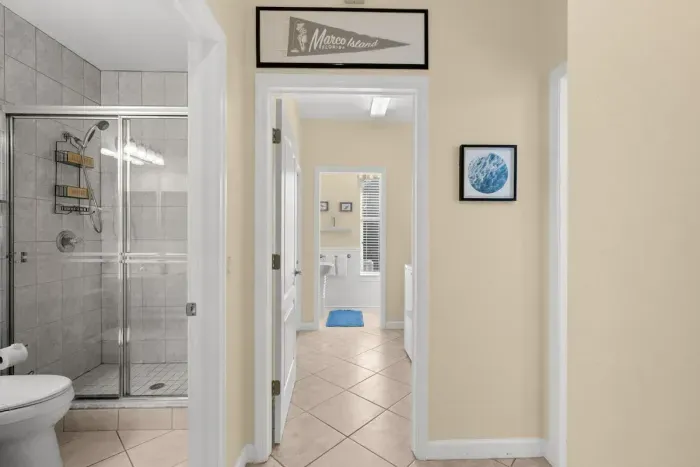 Hallway Bathroom: Spa-like shower and beachy decor invite rejuvenation after sun-soaked adventures!