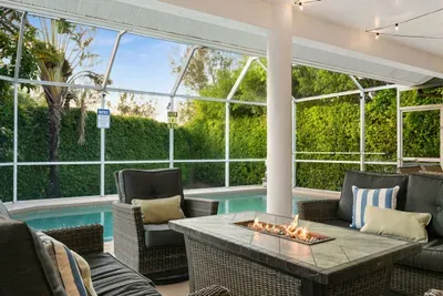 Outdoor Lounge: Relax by the pool with friends around a fire feature and lush greenery!