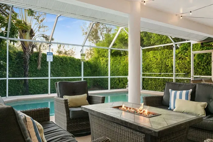 Outdoor Lounge: Relax by the pool with friends around a fire feature and lush greenery!