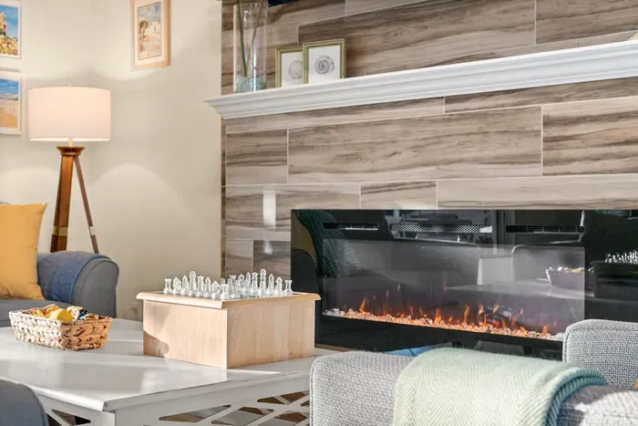 Living Room: Enjoy game nights by the glowing fireplace and modern decor in this stylish retreat!