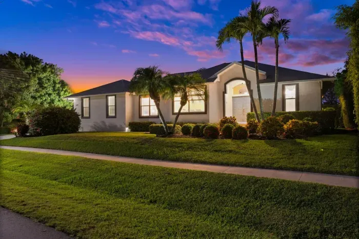 Charming Exterior: Stroll through lush greenery to this inviting Marco Island getaway!
