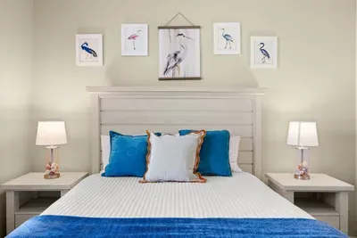 Bedroom Oasis: Drift into serenity surrounded by chic decor and ocean-inspired hues!