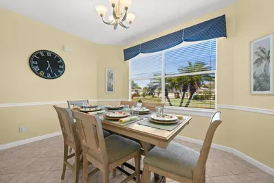 Dining Room: Bright space with charming decor and tropical views for lively meals and gatherings!