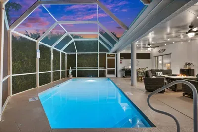 Outdoor Oasis: Dive into luxury with this stunning screened pool and inviting lounge area!