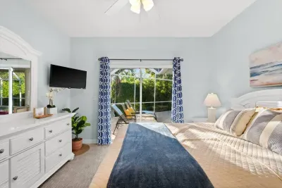Bedroom Retreat: Light-filled sanctuary with pool views and beach-inspired decor awaits!