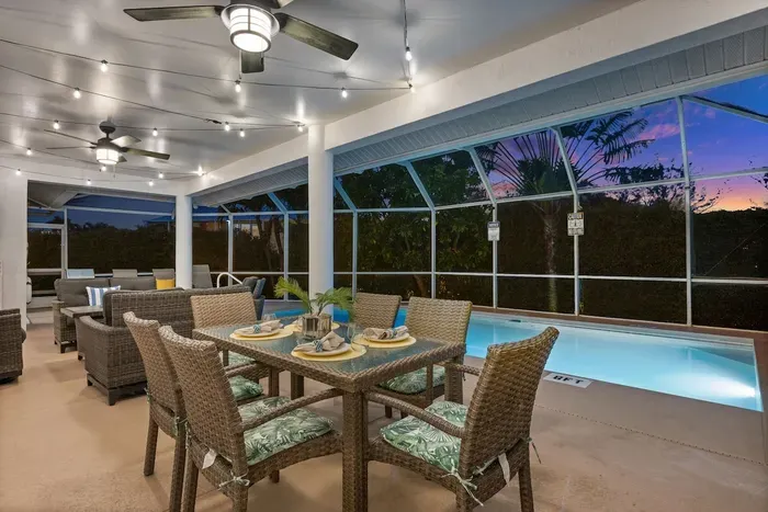 Outdoor Oasis: Dine al fresco under twinkling lights by the sparkling pool—pure vacation bliss!