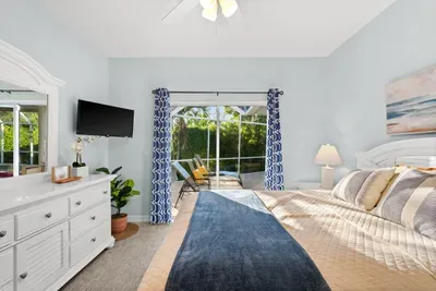 Bedroom Retreat: Light-filled sanctuary with pool views and beach-inspired decor awaits!
