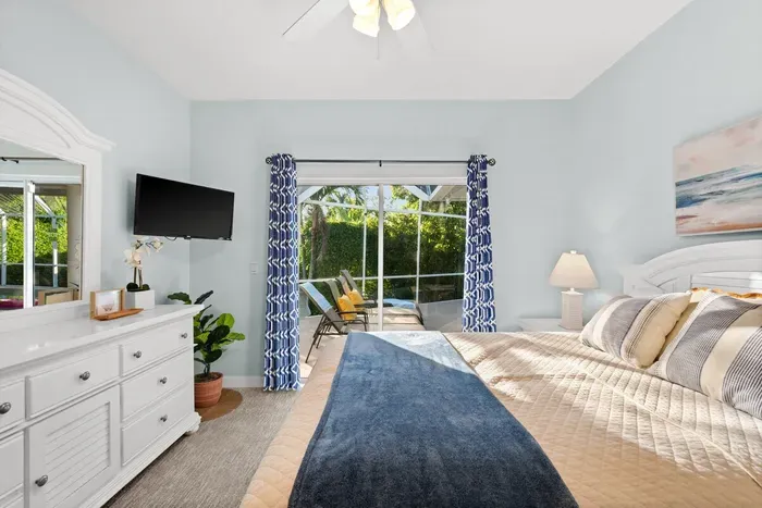 Bedroom Retreat: Light-filled sanctuary with pool views and beach-inspired decor awaits!